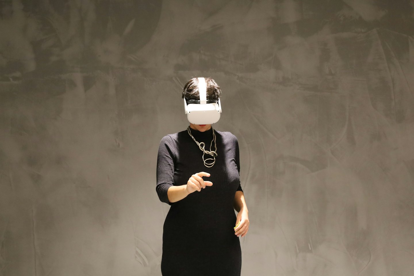 Persona con visore VR bianco che pizzica l'aria.